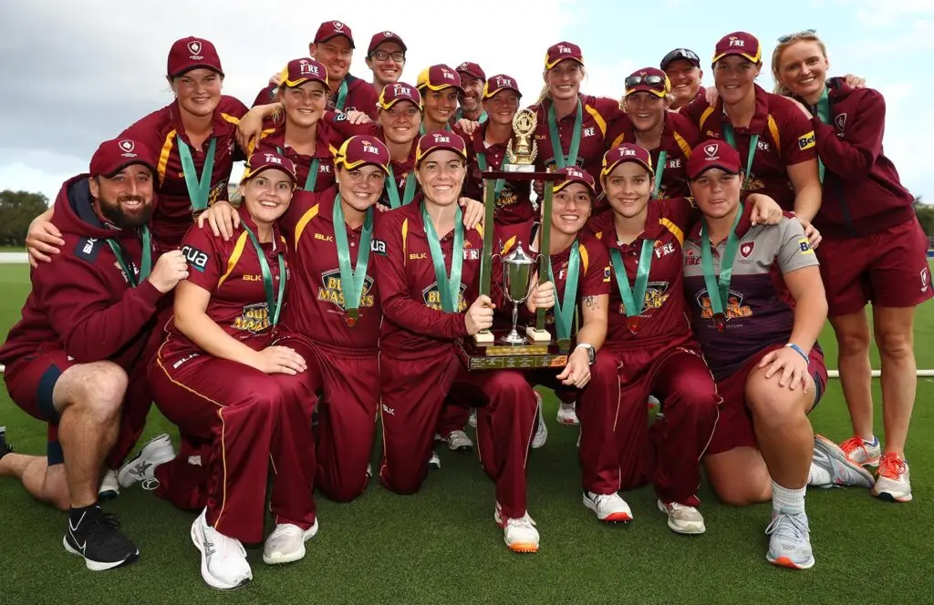 The Queensland Fire women's team celebrate their first title win in the 2020-2021 season