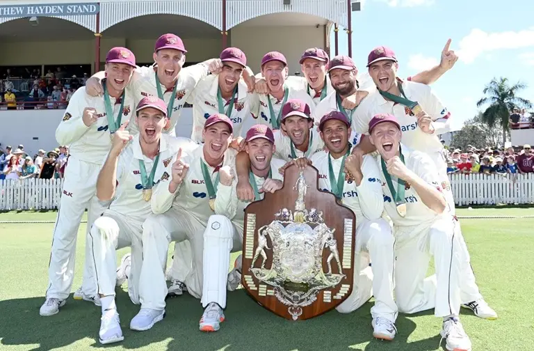 Queensland Cricket players celebrate winning the Sheffield Shield title in the 2020-2021 season