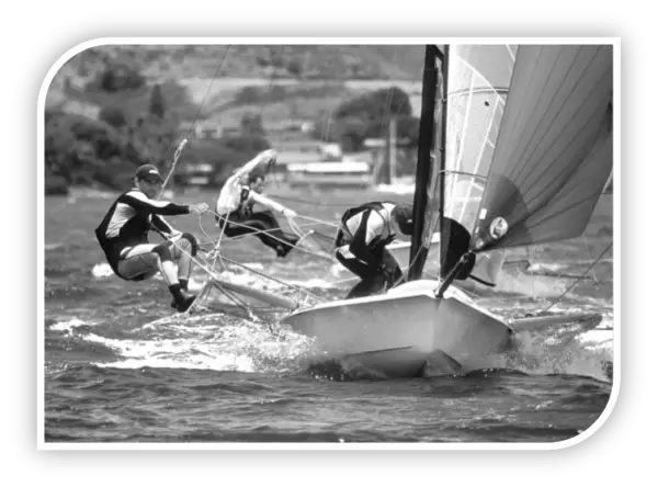 49er crews out on trapeze racing in a stiff breeze, in black and white